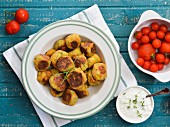 Fried vegetable balls with a cream sauce and cherry tomatoes