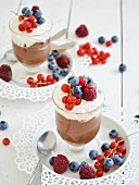 Chocolate pudding with whipped cream and fresh berries