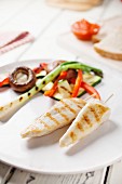 Marinated grilled chicken strips with vegetables