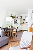 Dining table and kitchen in vintage-style open-plan interior