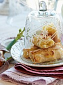 Almond filo pastries under a bell jar