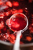 Strawberry jam on a ladle