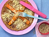 A wholemeal pancake with carrots and sesame seeds