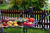 An autumnal buffet on a wooden table in a garden