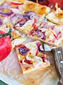 Spicy puff pastry tray bake cake with apples, onions and bacon