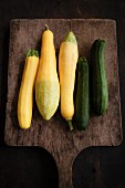 Yellow and green zucchinis on a chopping board