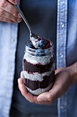 Chia pudding with blueberries layered in a screw top glass (Superfood)