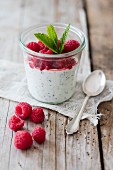 Soya yoghurt with chia seeds and raspberries in a glass