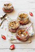 Small strawberry crumbles in glass jars