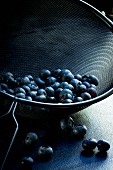 Blueberries in a black metal sieve