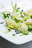 Cauliflower salad with fresh ginger, pumpkin seeds, spring onions and pumpkin seed oil