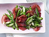 Pan-fried green asparagus with Italian beef ham