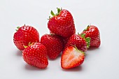 Several strawberries against a white background