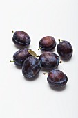 Damsons on a white surface