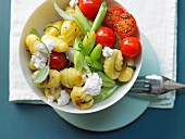 Gnocchi with cherry tomatoes, spring onions and rocket