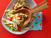 Spiral pasta with tomato, leek and nuts