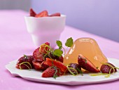 Apple and rhubarb jelly tipped onto a plate and served with marinated strawberries