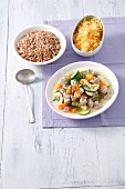 Pork goulash with vegetables served with buckwheat and sauerkraut salad