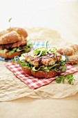 A Chinese chicken burger with cucumber and spring onions