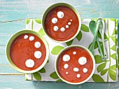 Orange and tomato soup with cream rosettes