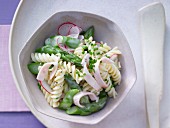Pasta and asparagus salad with radish and turkey breast