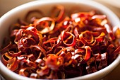 Dried chilli rings in a bowl (close-up)