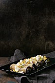Aubergine rolls with ricotta, garlic, cheese sauce and pistachio nuts