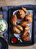 Chicken in a spicy polenta coating with chilli sauce and coleslaw