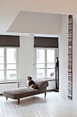 White wooden floor and dog on antique chaise longue in renovated period apartment