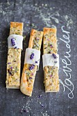 Slices of onion cake with lavender flowers and basil salt