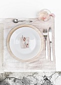Place setting on pale pink place mat dyed using hydrangea flowers