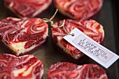 Marbled heart-shaped mini cheesecakes with a gift tag for Valentine's Day
