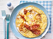 An omelette with potato, bacon and apple