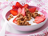 Crunchy cashew nut and spelt wheat cereal with yoghurt and strawberries