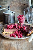 Chocolate tart with a baked chocolate custard filling and raspberries