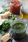 Green and red pesto in glass jars