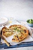 Carmelised onion and blue cheese quiche with rosemary, sliced with one slice removed