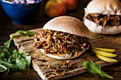 A pulled pork burger with apple and salad