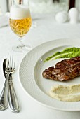 Grilled beef steak with celery puree and pea puree