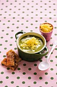 Green vegetable soup with leaf spinach, broccoli, Cheddar cheese and toast soldiers