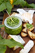 Pesto in a glass with bread and cheese