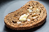 A slice of wholemeal toast with melting butter