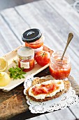 Tomato jam in jars and on bread