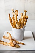 Savoury puff pastry straws in a mini bucket