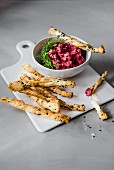 Beetroot & feta cheese dip with savoury puff pastry straws garnished with dill
