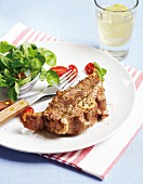 Grilled lamb chop with garlic, pepper and salad