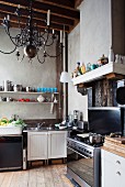 Gas cooker, sink and bracket shelves in rustic kitchen