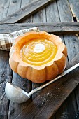 Cream of pumpkin soup in hollowed-out pumpkin