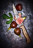 Fresh red figs with a leaf and a knife
