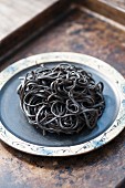 Black squid ink pasta on a plate